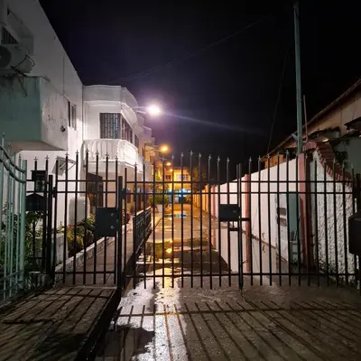 a gate in front of a street at night at Habitación Girasoles in Cartagena de Indias