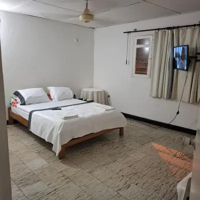 a bedroom with a large bed in a room at Habitación Girasoles in Cartagena de Indias