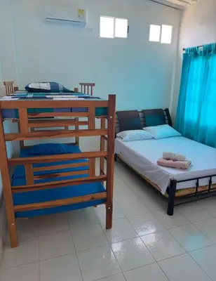 a bedroom with two bunk beds with blue curtains at Casa Campestre Valle del Mar in Santa Marta