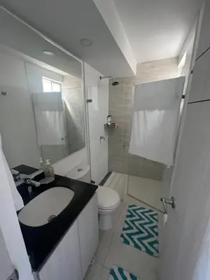 a small bathroom with a sink and a toilet at Nuevo apartamento de lujo con balcón wifi AC piscina in Barranquilla