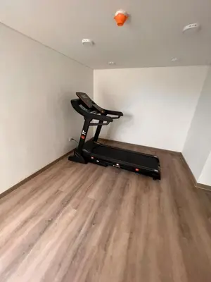 a room with a gym with a bench and an orange ball at Nuevo apartamento de lujo con balcón wifi AC piscina in Barranquilla