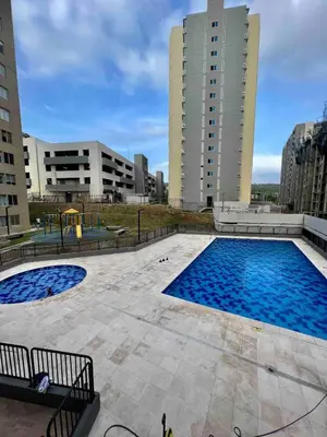 a large swimming pool with two tall buildings at Nuevo apartamento de lujo con balcón wifi AC piscina in Barranquilla