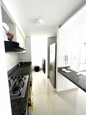 a kitchen with a stove and a counter top at Nuevo apartamento de lujo con balcón wifi AC piscina in Barranquilla