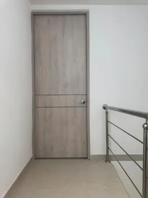 a wooden door in a room with a staircase at Comfort Retreat in Bocagrande in Cartagena de Indias