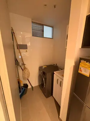 a small kitchen with a washing machine and a washer at District Aptosuite 404 in Barranquilla