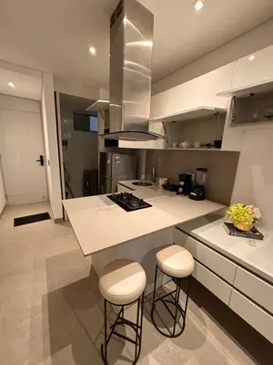 a kitchen with a counter and stools in it at District Aptosuite 404 in Barranquilla