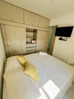 a bedroom with a large white bed with yellow pillows at Beautiful view in Cartagena in Cartagena de Indias