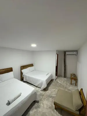 a room with two beds and a table in it at Euphoria Beach in Playa Blanca