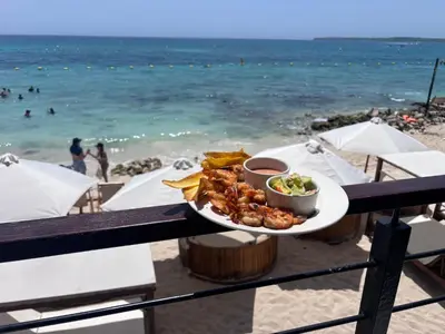 a plate of food on a table on the beach at Euphoria Beach in Playa Blanca