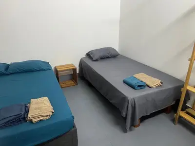 a room with two beds and a ladder at Habitación cerca de la playa 203 in Cartagena de Indias