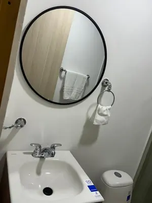 a bathroom with a mirror and a sink and a toilet at Casa ayola in Cartagena de Indias