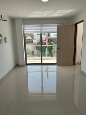 an empty room with a large window and a door at Casa ayola in Cartagena de Indias