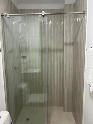 a shower with a glass door in a bathroom at Casa ayola in Cartagena de Indias