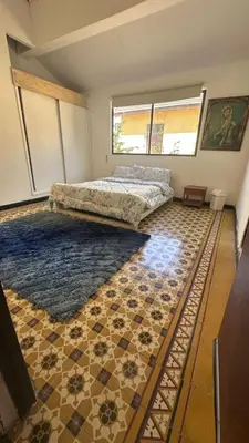 a room with a bed and a rug on the floor at Apartamento de la A samblea in Cartagena de Indias