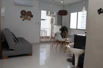 a living room with a couch and a table at Encantador Apartamento El Laguito Bocagrande in Cartagena de Indias