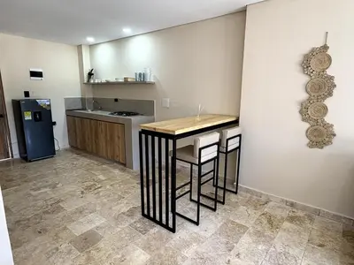 a kitchen with a table and a refrigerator in a room at Apartment in Coveñas FOREST in Coveñas