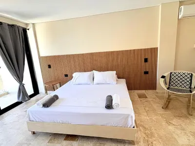 a bedroom with a bed and a chair in it at Apartment in Coveñas FOREST in Coveñas