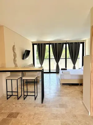 a bedroom with a bed and a table and two stools at Apartment in Coveñas FOREST in Coveñas