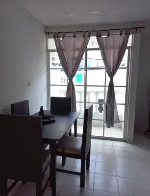 a dining room with a table and chairs and a window at Apartamento hostal oasis 2 in Puerto Colombia