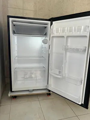 an empty refrigerator with its door open in a kitchen at Apartamento hostal oasis 2 in Puerto Colombia