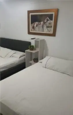 a bedroom with a white bed and a couch at Apartastudio 1 Habitacion - Manga in Cartagena de Indias