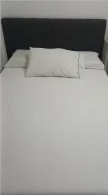 a white bed with two pillows on top of it at Apartastudio 1 Habitacion - Manga in Cartagena de Indias