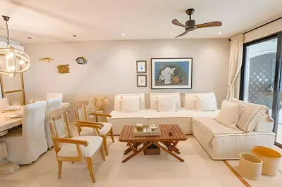 a living room with a white couch and a table at Modern and cozy Beachfront house Santa Marta 7pax in Simón Bolívar International Airport