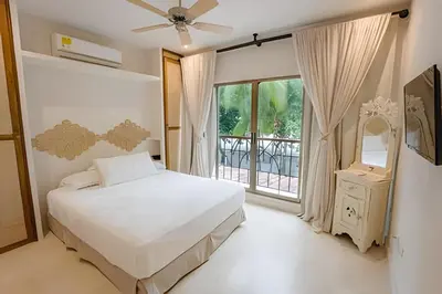 a bedroom with a bed and a large window at Modern and cozy Beachfront house Santa Marta 7pax in Simón Bolívar International Airport