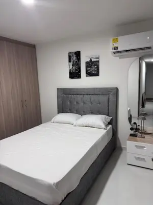 a bedroom with a large bed and a television at Apartmento en Ciudad Mallorquín in Puerto Colombia