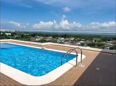 a swimming pool with a view of the ocean at Apartment with large balcony in Cartagena de Indias