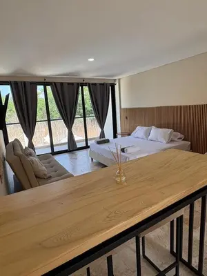 a bedroom with a bed and a table in front of it at Forest Condominio in Coveñas