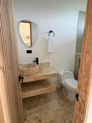 a bathroom with a sink and a toilet and a mirror at Forest Condominio in Coveñas