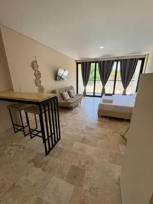 a living room with a couch and a table at Forest Condominio in Coveñas