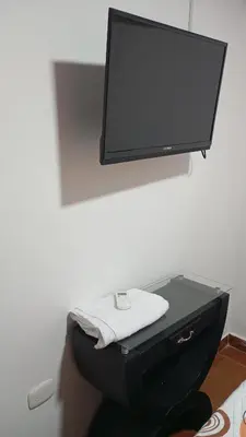 a bathroom with a toilet with a tv on the wall at Apartamento #4 in Puerto Colombia
