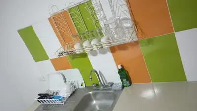 a kitchen with a sink and a drying rack on the wall at Apartamento #4 in Puerto Colombia