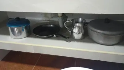 a kitchen counter with pots and pans on a shelf at Apartamento #4 in Puerto Colombia