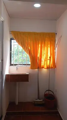 a bathroom with a sink and an orange curtain at Apartamento #5 in Puerto Colombia