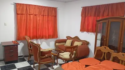 a room with chairs and a bed and a dresser at Apartamento #6 in Puerto Colombia