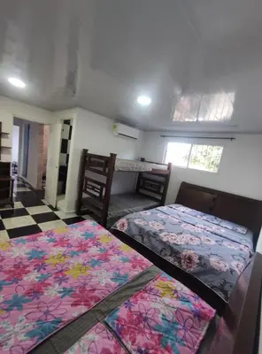 a bedroom with two beds and a room with at Apartamento #6 in Puerto Colombia