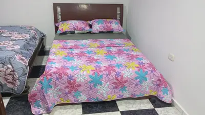 a bed with a colorful bedspread on it at Apartamento #6 in Puerto Colombia