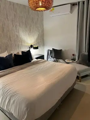 a bedroom with a large white bed and a couch at the best view of Barranquilla in Barranquilla