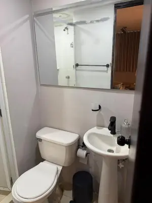 a white bathroom with a toilet and a sink at the best view of Barranquilla in Barranquilla
