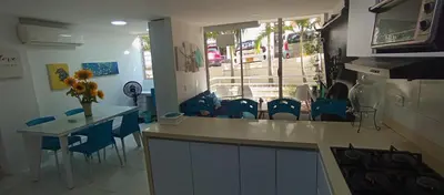 a kitchen with blue chairs and a table and a counter at Apto para 6, cerca a la ciudad amurallada in Cartagena de Indias