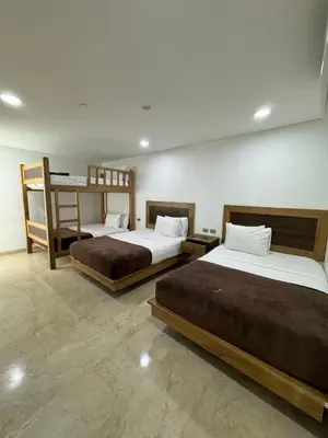two beds in a room with two bunk beds at Hotel Odonata Real in Cartagena de Indias