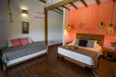 a bedroom with two beds and a mirror at Casa del Mar by Al Alma in San Onofre