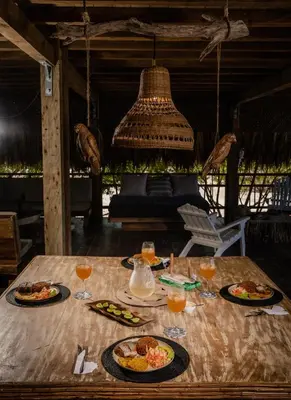 a table with plates of food and glasses of orange juice at Casa del Mar by Al Alma in San Onofre