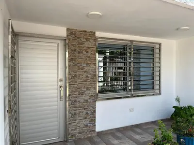 a house with a door and a window at Acogedor y Moderno Apartamento en Barranquilla in Barranquilla