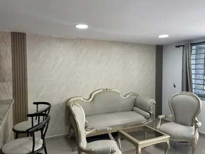 a living room with a couch and two chairs at Acogedor y Moderno Apartamento en Barranquilla in Barranquilla