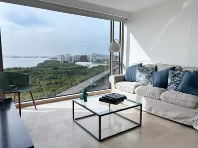 a living room with a couch and a glass table at Beachfront Apartment at Radisson Hotel in Cartagena de Indias