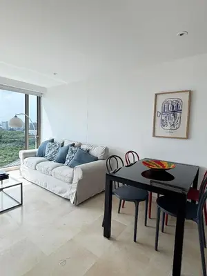 a living room with a couch and a table at Beachfront Apartment at Radisson Hotel in Cartagena de Indias